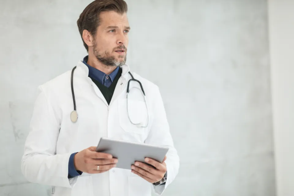 A doctor holding a tablet