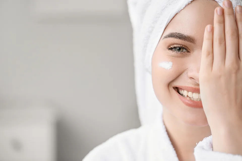 A woman touching the smooth skin of her cheek